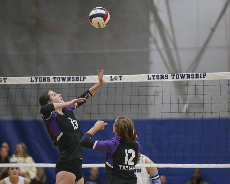 Downers Grove North's Nora Benjamins (13) lines up a kill after being set by Madi Mastalarz (12) during Class 4A Lyons Sectional Semifinal volleyball match between Downers Grove South at Downers Grove North. Nov 4, 2025 in La Grange.
