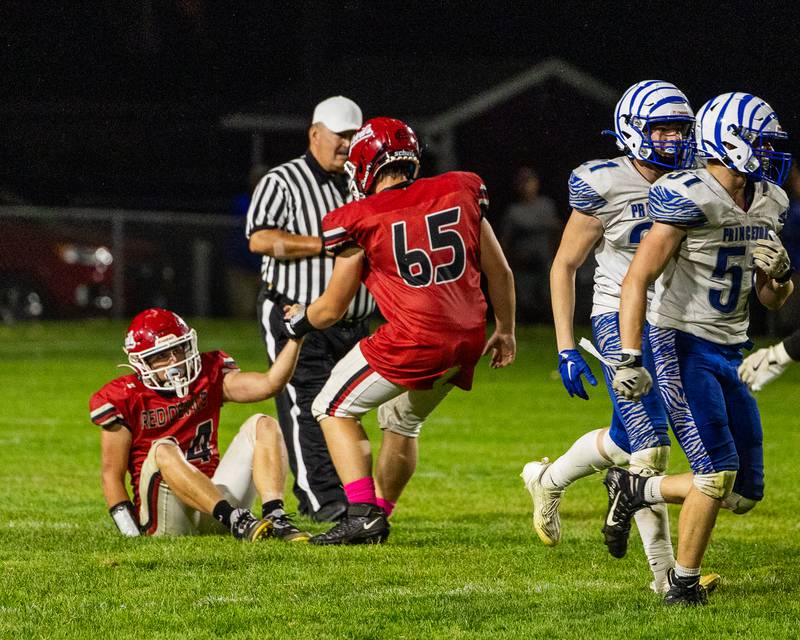 Aiden Redcliff (34) of Hall is helped up by teammate Caden Ellena (65) after being tackled on Friday, Oct. 3, 2025 at Richard Nesti Stadium in Spring Valley.