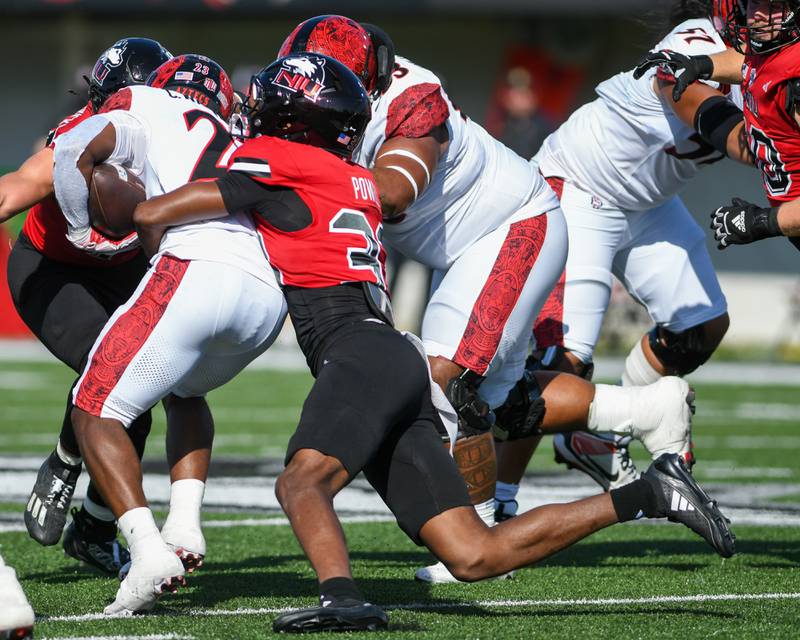 Northern Illinois University's defensive back Taylor Powell (33) takes down San Diego State’s ball carrier Christian Washington during the game on Saturday Sept. 27, 2025, held at Huskie Stadium in DeKalb.
