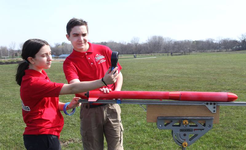 Lilly Abney, of Round Lake Beach and Luka Weideman, of Lindenhurst, both 14, with the Prince of Peace Redhawk Rocketeers TARC Team look at an anemometer to see the speed of wind before test launching their rocket to compete in the upcoming American Rocketry Challenge at the Tim Osmond Sports Complex in Antioch. The finals are held next month in Washington, D.C. on May 14th.