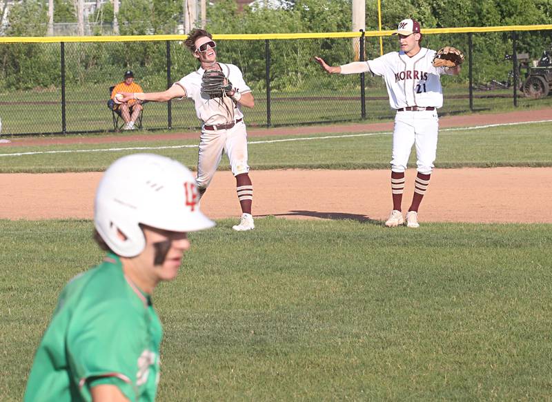 Morris's Brett Bounds throws to first to force out L-P's Jack Jereb during the Class 3A Regional semifinal game at Huby Sarver Field in La Salle.