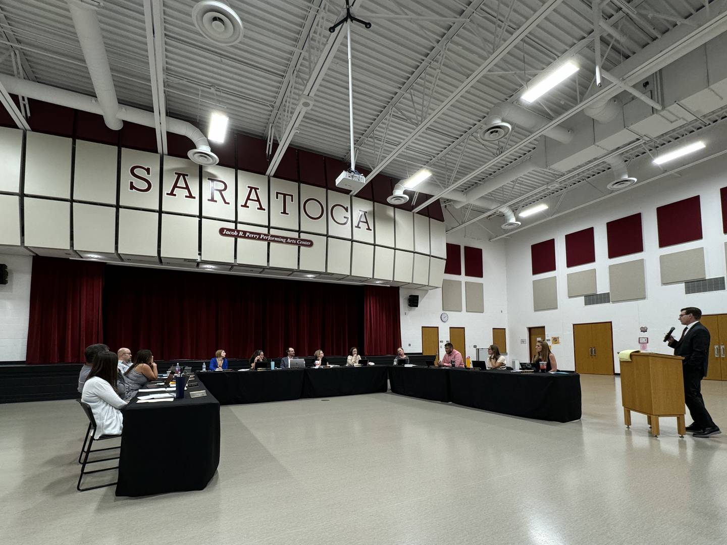 Attorney Kevin Gordon (right) explains the process the school board would go through if it decided to contract out Saratoga Elementary School's bus system.