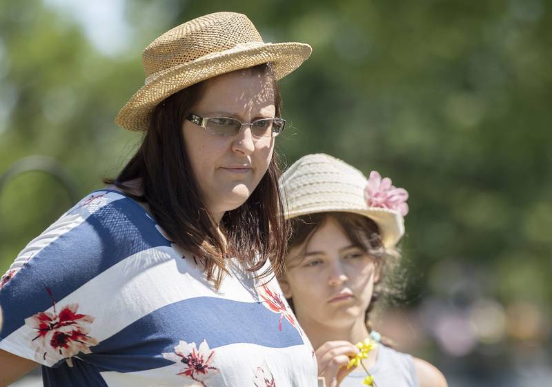 Amanda Ganze and daughter Serina Ganze wear hats in memory of grandmother Ruth Ann Pullen while graveside Friday, July 7, 2023. Pullen was known for her stylish headwear.