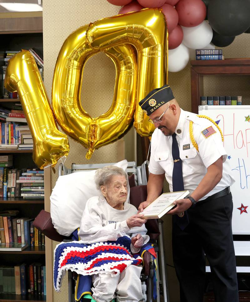 Manuel Olalde, post commander for DeKalb American Legion Post 66, presents World War II veteran Myrtle Annetta Lusiak with a proclamation Thursday, May 2, 2024, during her birthday celebration at Aperion Care in DeKalb. Lusiak, who turned 107-years-old, served in the Women’s Army Corps from Aug. 5, 1943 until her honorable discharge on Nov. 27, 1945.