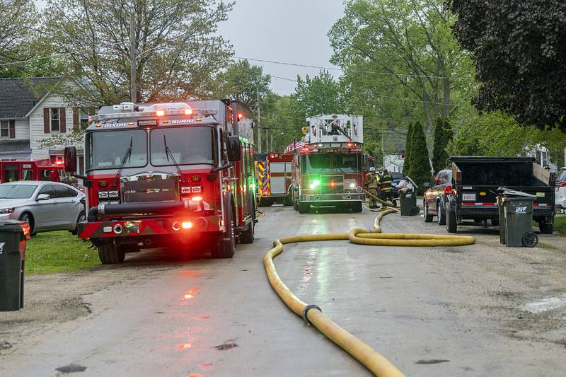 Firetrucks, hoses, police and first responders clog Avenue I in Sterling Monday, April 27, 2026, to fight a house fire.