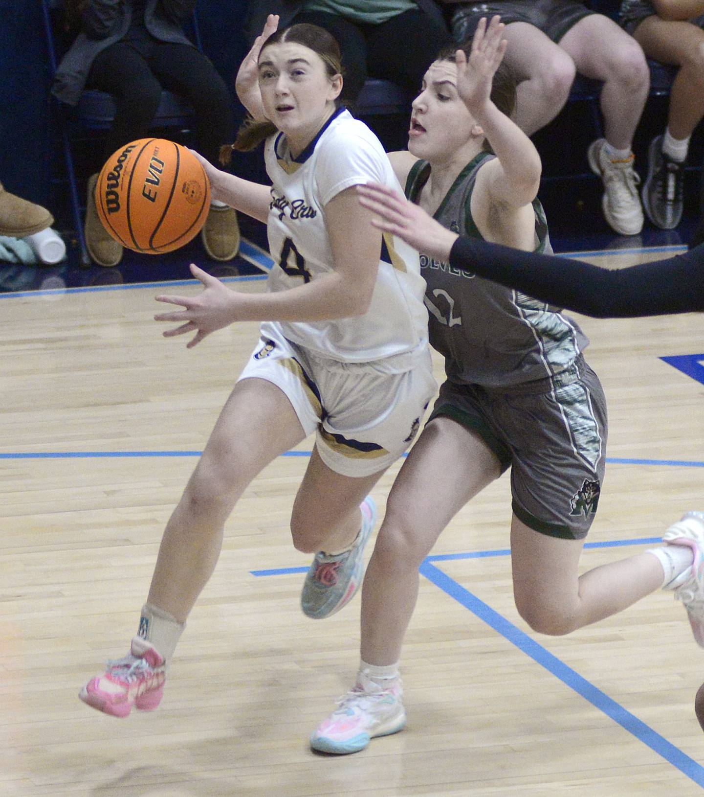 Marquette’s Hunter Hopkins drives to the basket past Midland’s Emma Franks during a game last season at Bader Gym in Ottawa.