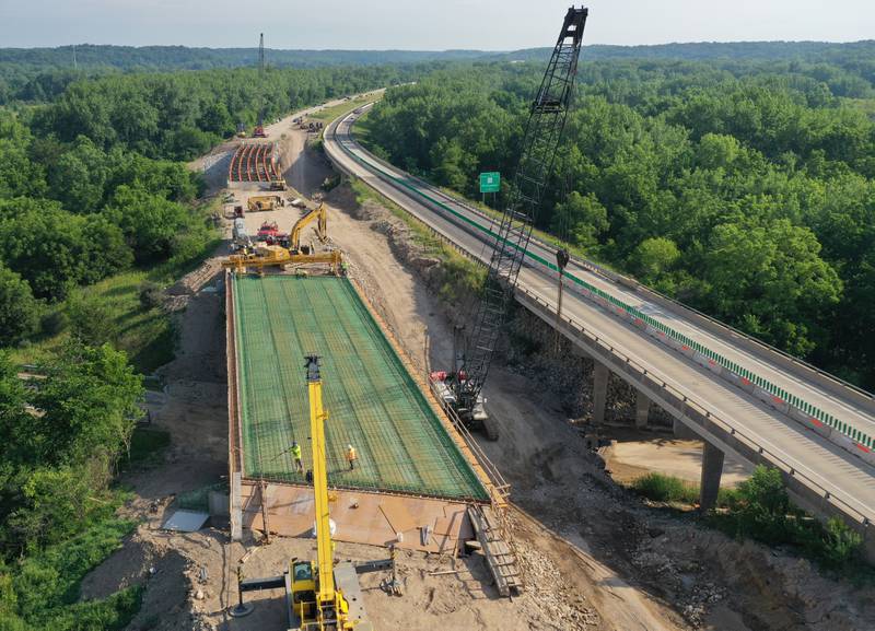 An aerial view of crews working on the Interstate 180 bridge crossing over Tiskilwa Bottom Road on Tuesday, July 8, 2025 near Tiskilwa. The Illinois Department of Transportation continues to work on the 180 bridges over Bureau Creek and Tiskilwa Bottom Road.  The I-180 work zone is a mile south of the Route 26 interchange. Both the south and northbound bridges are being replaced. Girders have been installed on the bridge. Tiskilwa Bottom Road remains closed under I-180 during the project and traffic should follow the posted detour signs. The 24.2 million project is scheduled to be completed by the end of 2026.