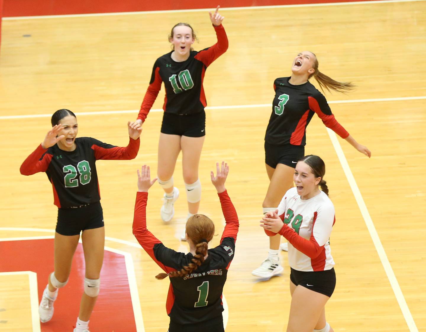 Members of the L-P volleyball team (from clockwise Ava Currie, Katie Sowers, Kaylee Abens, Marissa Sanchez and Addison Duttlinger react after scoring a point against Ottawa on Thursday, Sept. 21, 2023 at Kingman Gym.