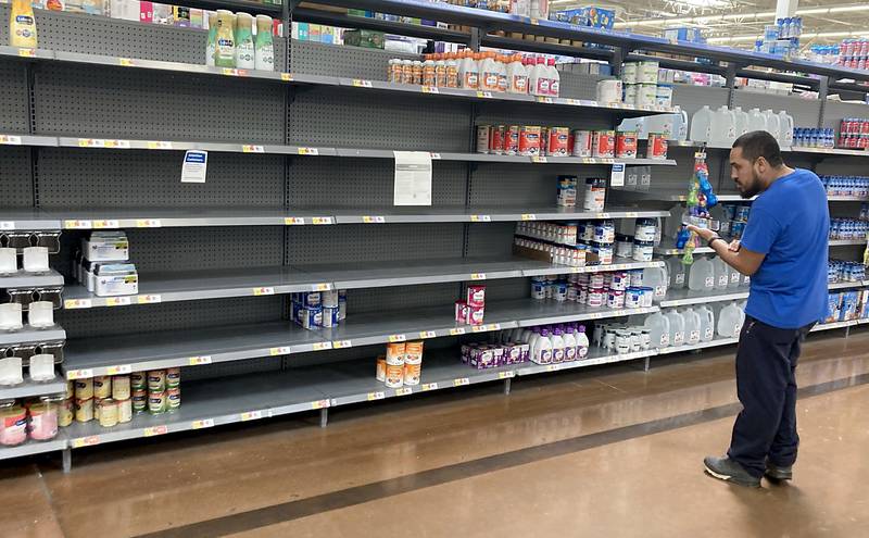 Ricardo Davila, of Marengo, looks for Similac 360 Total Care baby formula Tuesday, May 10, 2022, for his daughter. The Woodstock store was one of several big box stores he had visited in the hopes of finding formula, which has been hard to find because of a recall and supply chain problems.