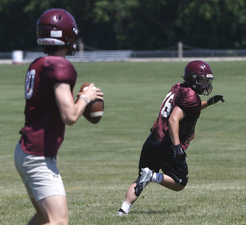 Marengo’s Joseph Leibrandt runs a route as Josh Holst looks to throw the ball during summer football practice Monday, June 27, 2022, at Marengo Community High School in Marengo.