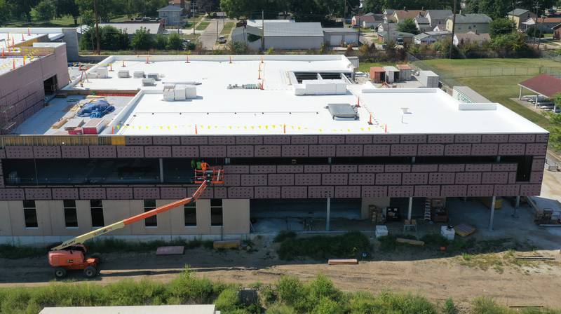 Workers use a lift to work on the exterior of the YMCA building on Monday, Aug. 28, 2023 in Ottawa.