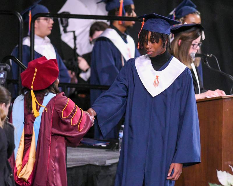 Oswego High school senior Marcus Braddock receives his diploma on Saturday May 17, 2025, during the graduation Ceremony held at the Convocation Center in DeKalb.