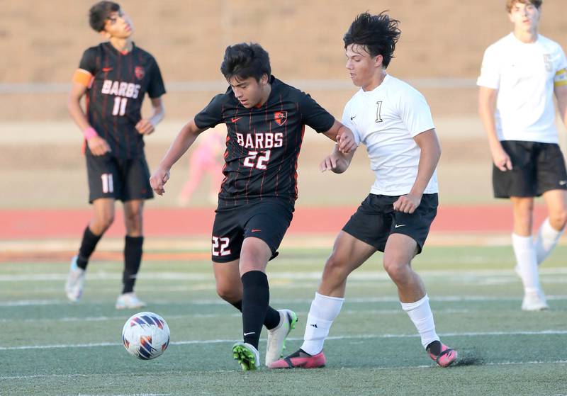 DeKalb's Jayson Quintero holds off Sycamore's Ethan Royer during their game Tuesday, Oct. 4, 2022, at DeKalb High School.