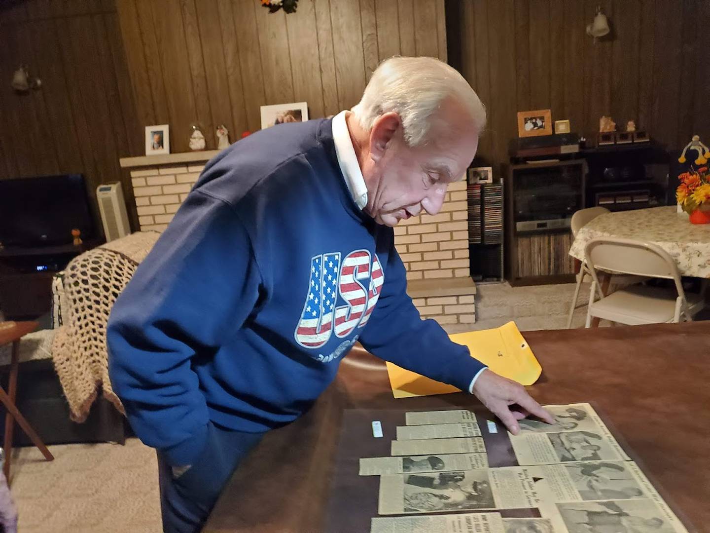 Robert Ceci of Joliet looks through old clippings from The Herald-News that Robert's mother Beverly Ceci had saved and laminated. These clippings are the only record Robert has of his father David Ceci's military service. David Ceci and four of his brothers had all served in the Army during World War II. One was killed in action and another was pronounced missing in action but later came home.