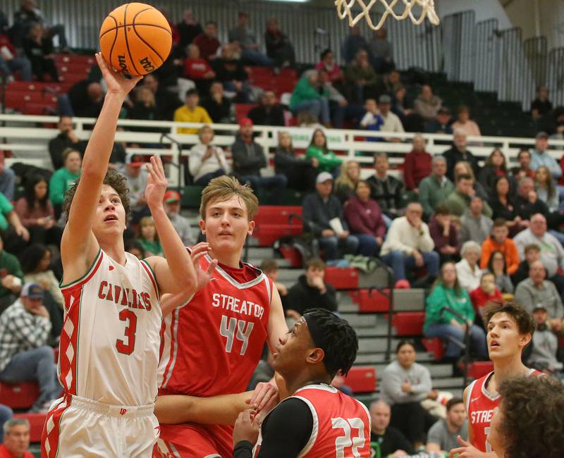 L-P's Mikey Hartman lets go of a shot over Streator's Nolan Lukach and teammate Tristan Finley on Tuesday, Jan. 14, 2025 in Sellett Gymnasium at L-P High School.