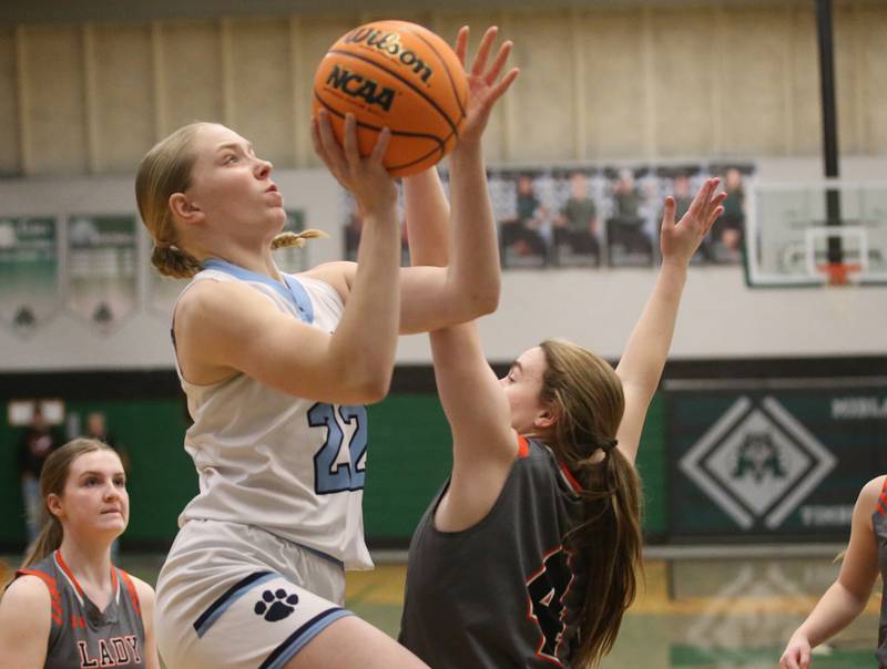 Cissna Park's Josie Neukomm drivs to the hoop as Flanagan-Cornell/Woodland's Aubry Edens defends during the Class 1A Sectional semifinal game on Tuesday, Feb. 25, 2025 at Midland HIgh School.