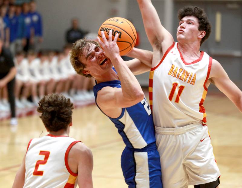 Geneva’s Jack Hatton tries to squeeze through Batavia’s Josh Kahley during a game on Friday, Dec. 20, 2024 in Batavia