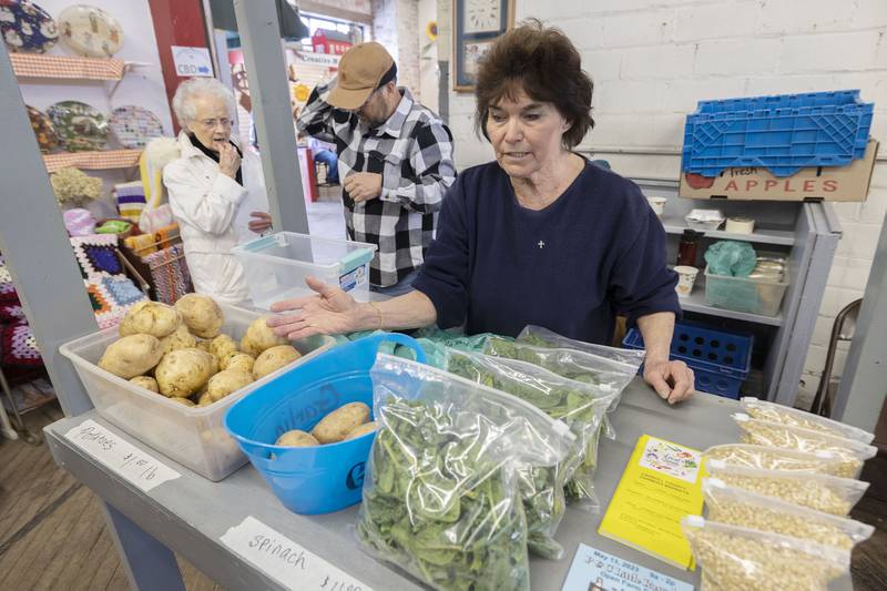 Janice Schell of Schell Farm Produce sells fresh spinach, potatoes and popcorn currently at the Twin City Framers Market. Once the growing season kicks in, the booth will offer many more items of produce.