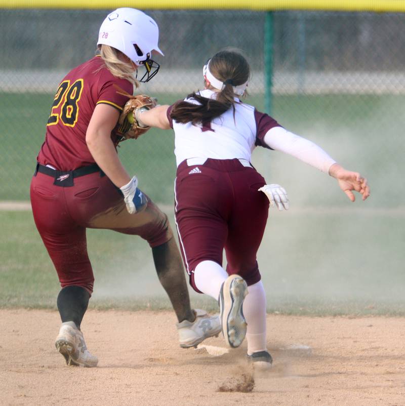 Marengo’s Gabby Christopher, right, tags out Richmond-Burton’s Madison Kunzer at second base in varsity softball at Marengo Tuesday.