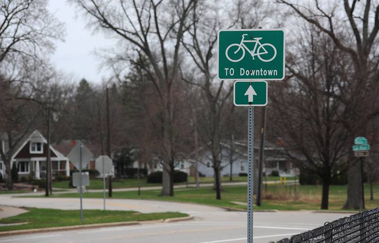 A bike route sign on Lake Shore Drive near Main Beach in Crystal Lake on April 13, 2022. The city has been working to make Crystal Lake more sustainable, environmentally friendly, and walkable.