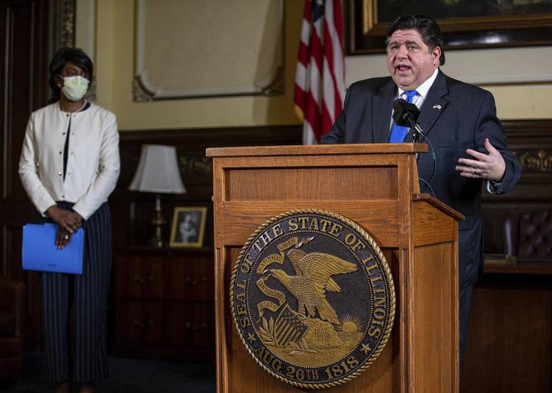 Illinois Gov. JB Pritzker answers questions from the media, along with Dr. Ngozi Ezike, left, director of the Illinois Department of Public Health, during his daily press briefing on the COVID-19 pandemic from his office at the Illinois State Capitol, Friday, May 22, 2020, in Springfield, Ill.