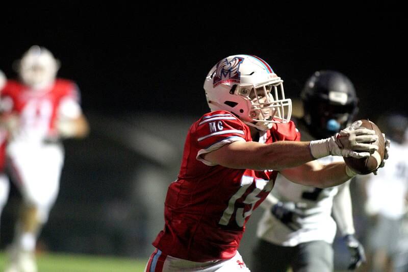 Marian Central’s Rylan Dolter hauls in a reception against Chicago Hope in varsity football at Woodstock Friday night.