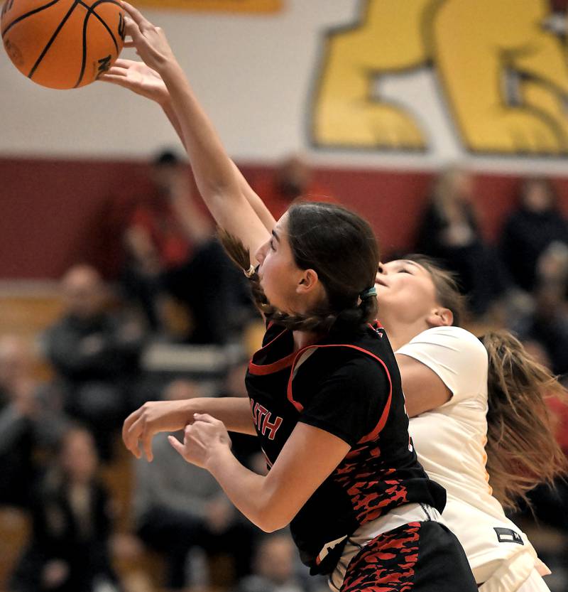 Maine South’s Amelia Fernandez blocks a shot by Batavia’s Hallie Crane in a girls basketball game in Batavia on Tuesday, Jan. 14, 2025.
