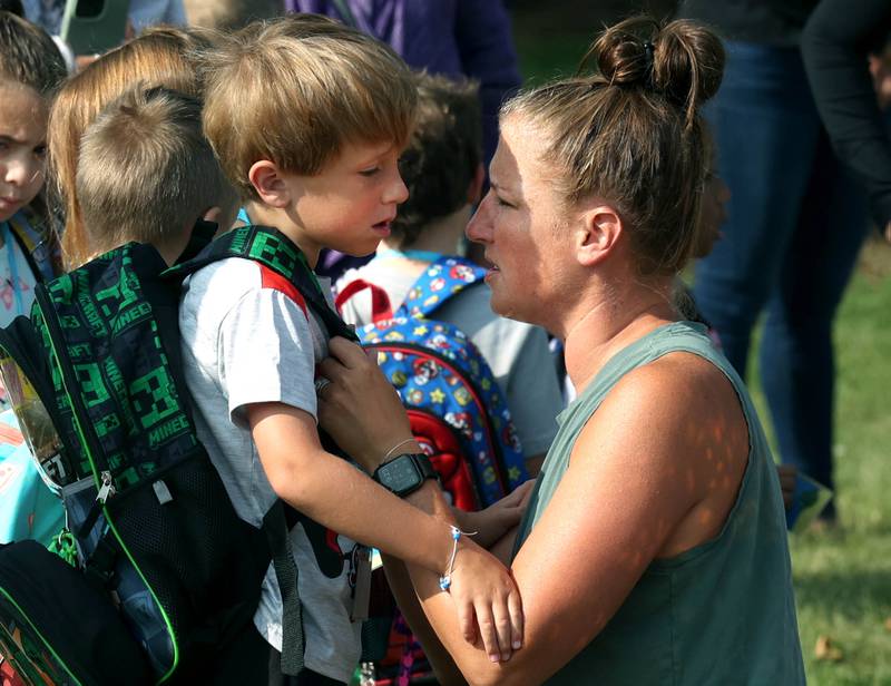 Logan Martin, a kindergartener at Southeast Elementary School, gets some encouraging words from his mom Jessie as they arrive for the first day of classes Thursday, Aug. 21, 2024, at the school in Sycamore.
