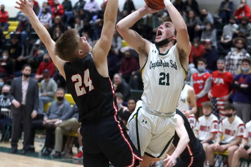 Crystal Lake South’s Cooper LePage takes a shot as Huntley’s Aiden Wieczorek defends in boys varsity basketball at Crystal Lake Friday night.