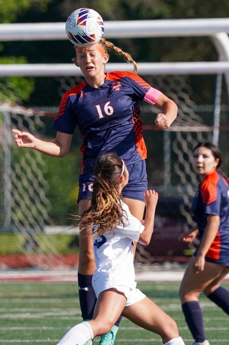 Oswego’s Peyton Johnson (16) goes up for a header against Oswego East's Kiara Taghap (23) during a Class 3A Lockport Regional semifinal soccer match at Lockport High School in Lockport on Wednesday, May 15, 2024.