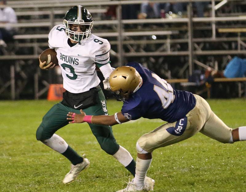 St. Bede's Hunter Savage runs the ball as Marquette's Marcus Baker makes the tackle on Friday, Oct. 13, 2023 at Gould Stadium.