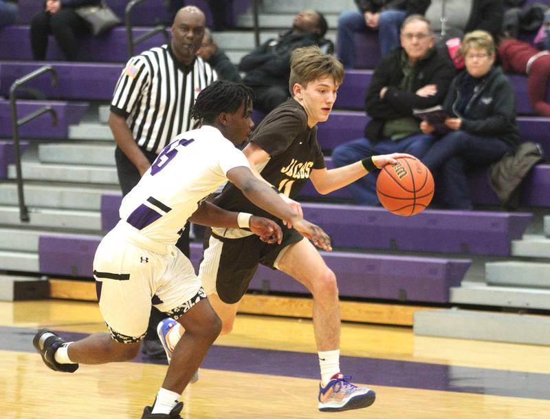 Hampshire’s Daniel Luckett, front, guards Jacobs’ Carter Roper in boys basketball at Hampshire on Tuesday.