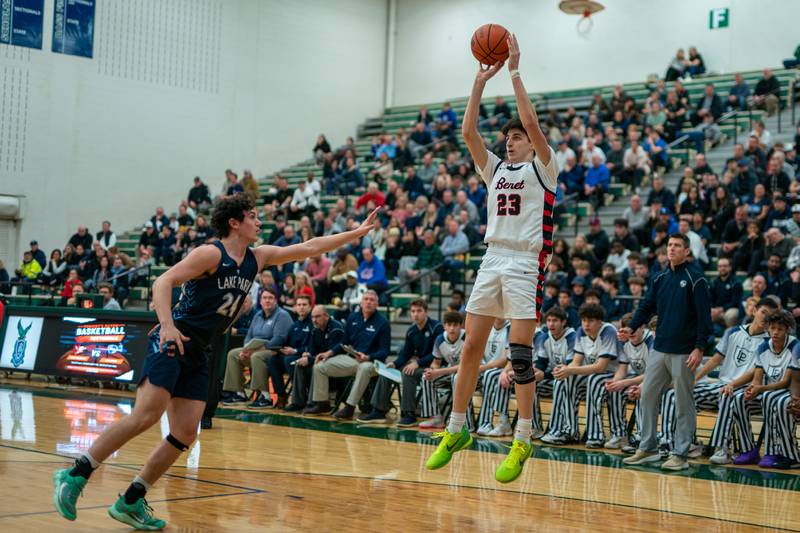 Benet’s Nikola Abusara (23) shoots a three-pointer against Lake Park's Dennasio LaGioia (24) during a Bartlett 4A Sectional semifinal boys basketball game at Bartlett High School on Tuesday, Feb 28, 2023.