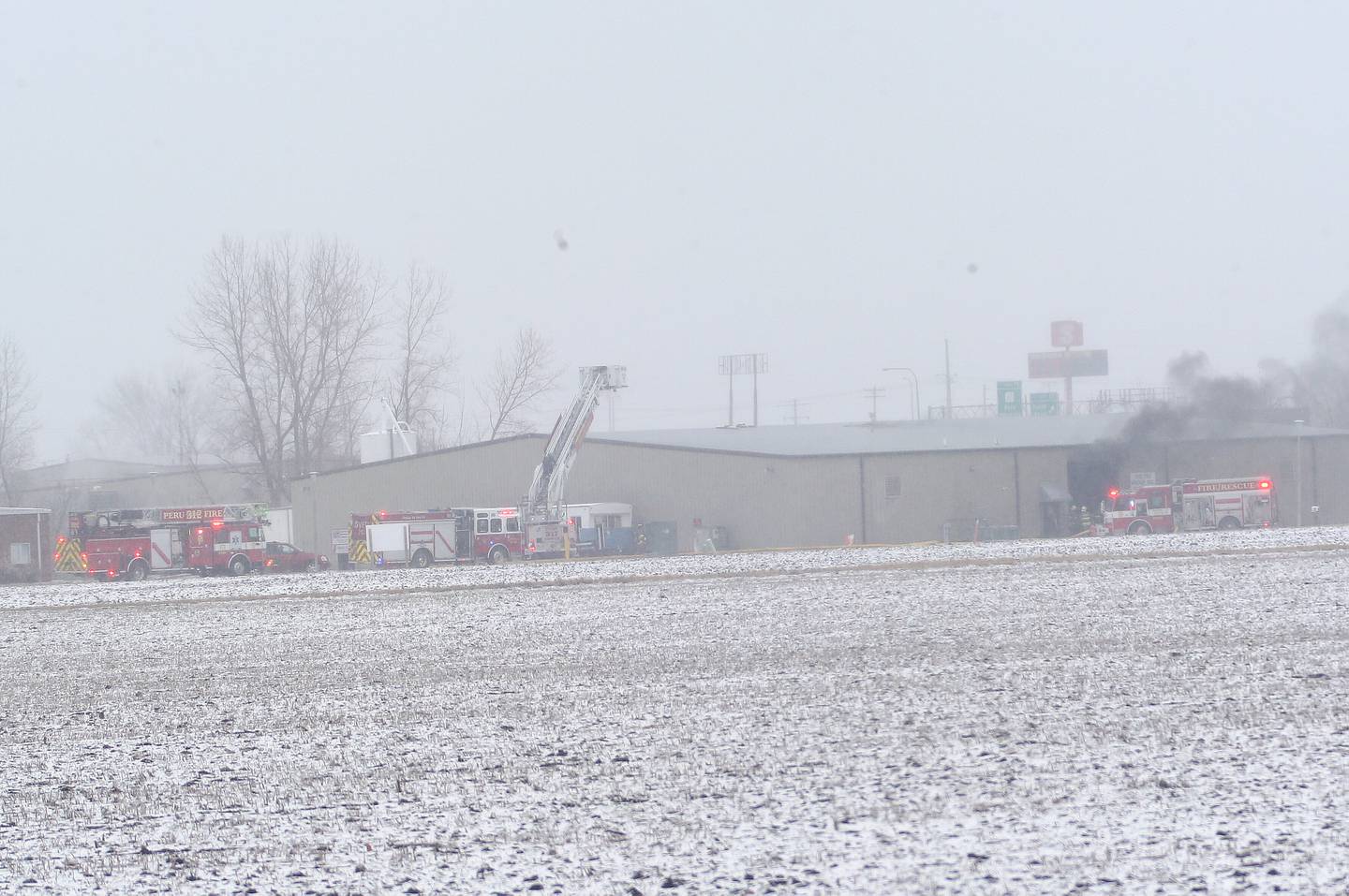 Firefighters work the scene of a structure fire at TDJ Group warehouse on Friday, Feb. 16, 2024 north of Peru. The fire began shortly after 11a.m. Fire departments from across the Illinois  Valley are responding to the scene.