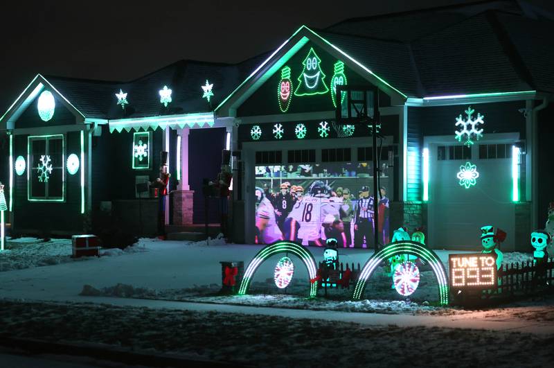 Chicago Bears highlights play on the garage door during light show put together by Tim Caravia and his family Friday, Jan. 16, 2025, at his home on Dustin Drive in Sycamore. The show will run from 5:30 to 9:00 p.m. most days until the Bears season ends.