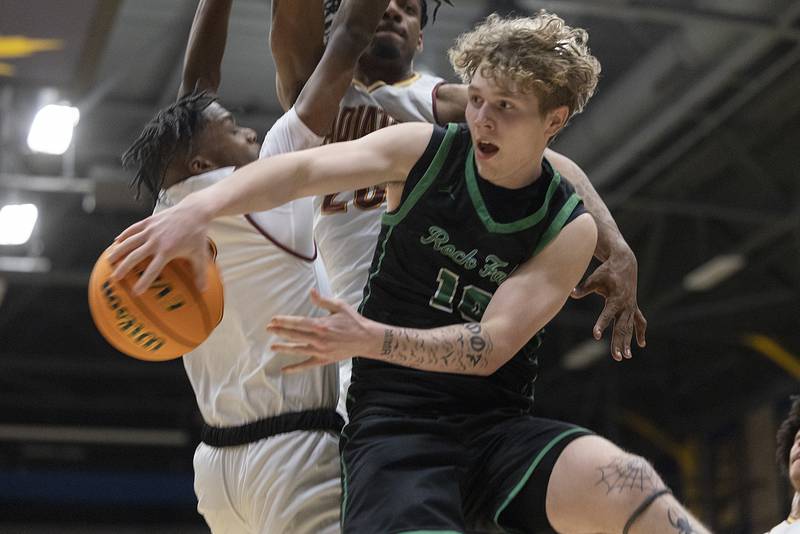 Rock Falls’ Kuitim Heald dishes off a pass against Christ the King defenders Monday, March 10, 2025, during the Class 2A boys basketball Supersectional in Sterling.
