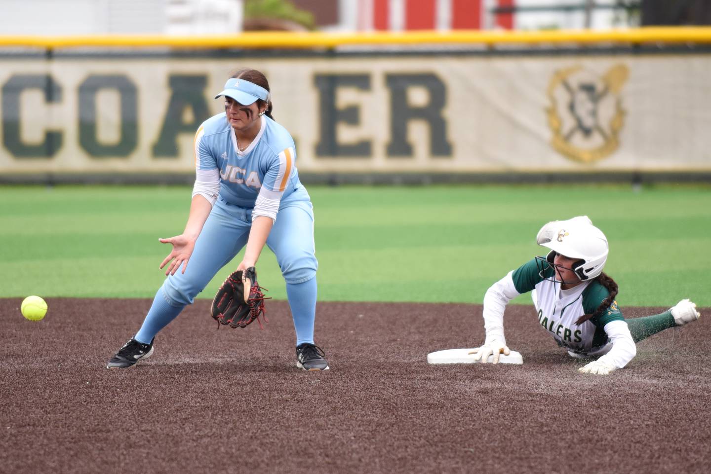 Joliet Catholic's Addy Rizzatto, left, fields a throw at second base as Coal City's Masyn Kuder slides in during the Class 2A Coal City Regional semifinals Wednesday, May 21, 2025.