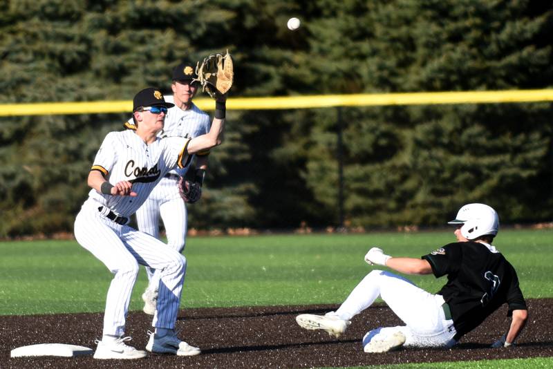 Reed-Custer's Matt Kuban, left, fields a throw at second base as Coal City's Lance Cuddy slides in for a stolen base during a game at Reed-Custer Tuesday, May 6, 2025.