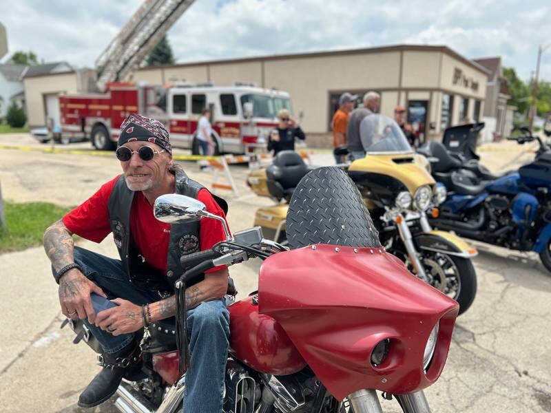 Stoney Vock of Savanna rests on his motorcycle in downtown Fulton on Sunday, June 2, 2024, just prior to the start of the annual Blessing of the Bikes.
