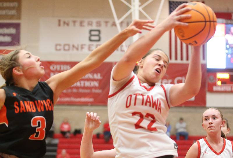 Ottawa's Marlie Orlandi grabs a rebound over Sandwich's Alee Subat on Monday, Jan. 27, 2025 in Kingman Gym at Ottawa High School.