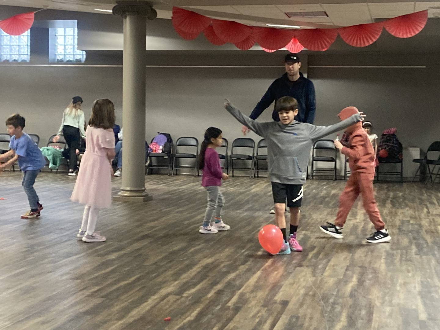 Dad Robert Sullivan organizes kids into a "balloon soccer" game at the Joliet Area Historical Museum's Valentine's Day Party on Feb. 8, 2025.