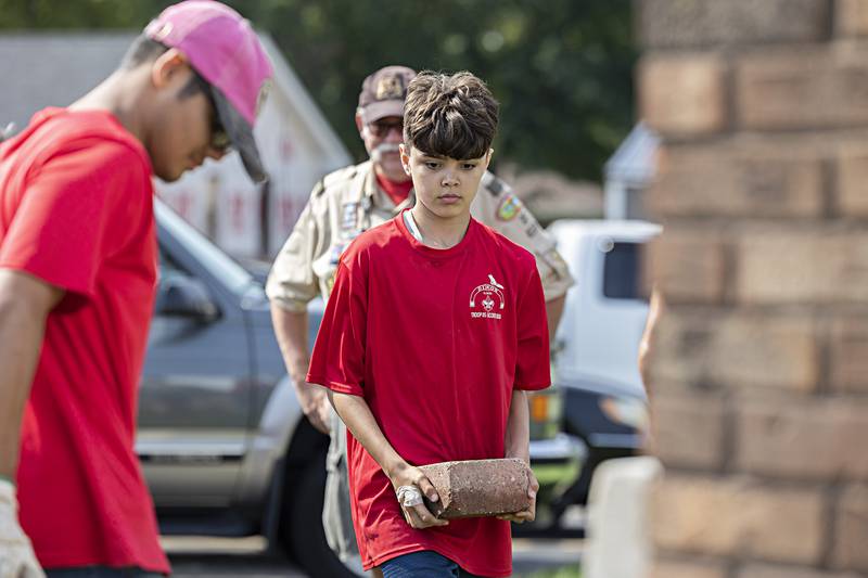 Scout troop 85 member Ayden Arnold, 11, lugs bricks for the Dixon project Saturday, Sept. 23, 2023.