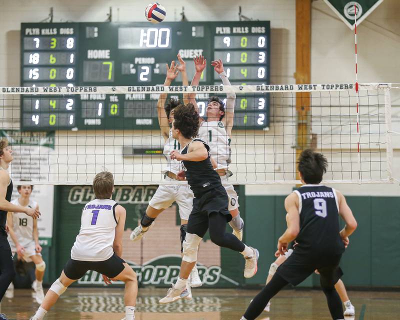 Glenbard West's Casey Maas (1) leaps high for a block attempt during volleyball match between Downers Grove North at Glenbard West.  April 2, 2024.