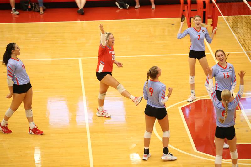 Members of the Ottawa volleyball team cheer with excitement after winning the first set against Plano on Thursday, Aug. 31, 2023 in Kingman Gym at Ottawa High School.