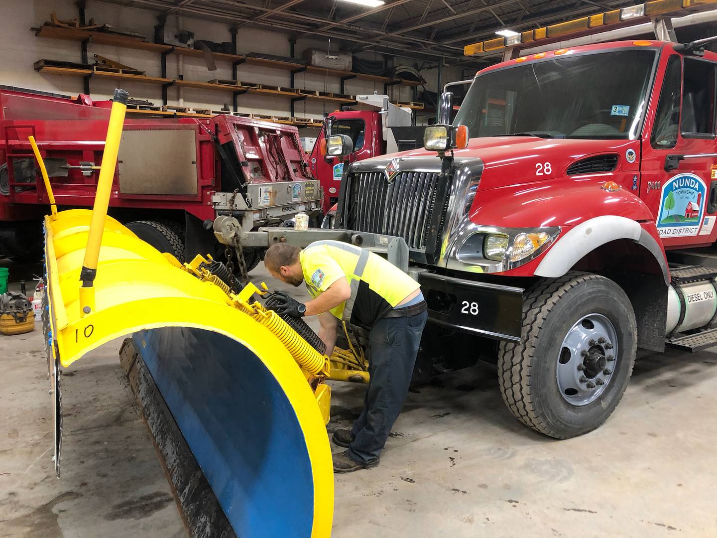 A Nunda Township Road District employee sets up the plow frame on a snow removal vehicle. The road district's Highway Commissioner Mike Lesperance won a ruling from a McHenry County judge last week in a lawsuit he filed against the Nunda Township Board of Trustees.