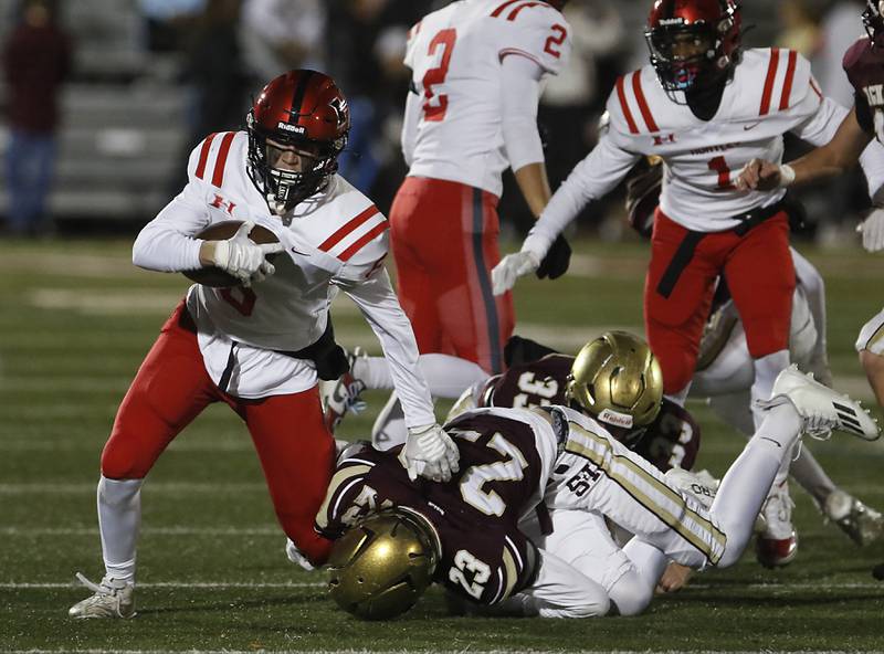 Huntley's Jacob Witt runs for a first down as St. Ignatius' Liam Doyle tries to tackle him during a IHSA Class 8A second round playoff football game on Friday, Nov. 3, 2023, at St. Ignatius College Prep in Chicago.