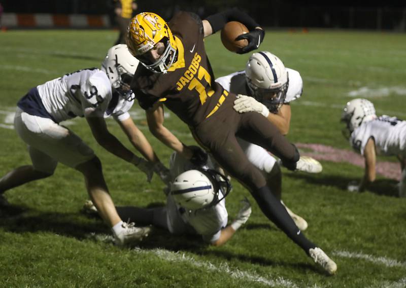Jacobs' Carson Goehring fights for extra yards against Cary-Grove during a Fox Valley Conference football game on Friday, Oct. 24, 2025, at Jacobs High School in Algonquin.
