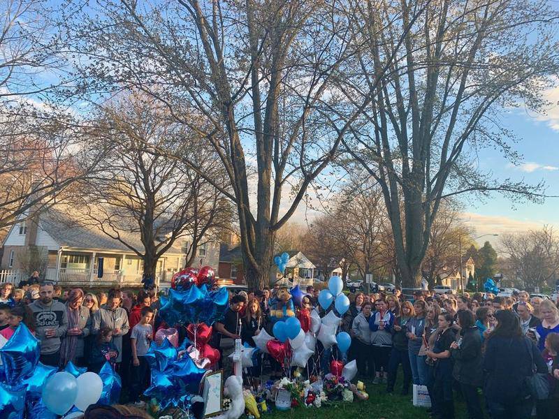 Thousands gather to honor Andrew "AJ" Freund on Wednesday night during a vigil outside his home at 92 Dole Ave. in Crystal Lake.