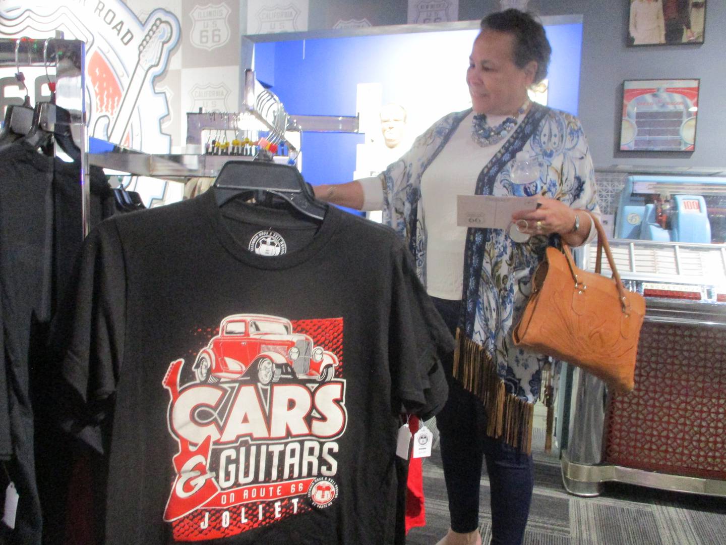 Melody Berry-Eskridge looks for a souvenir to bring home to her 99-year-old mother, Themetta Berry, after the opening of an exhibit on Saturday for her father, Chuck Berry, at the Illinois Rock and Roll Museum on Route 66 in Joliet. May 2, 2026