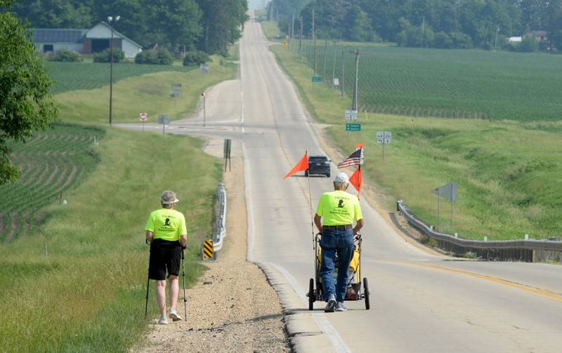 Dean Troutman and Kathy Woodward walk along Illinois 26, between Forreston and Polo on Sunday, June 4. Troutman, 92, of Princeville, Illinois, is walking to raise money for St. Jude's. Woodward of Galesburg, walked with Troutman from Dixon to Forreston. Her husband, Gene, followed them in the couple's vehicle. Woodward returned home on Sunday. Troutman his trek by himself, but invites others to join him during his daylight hours.